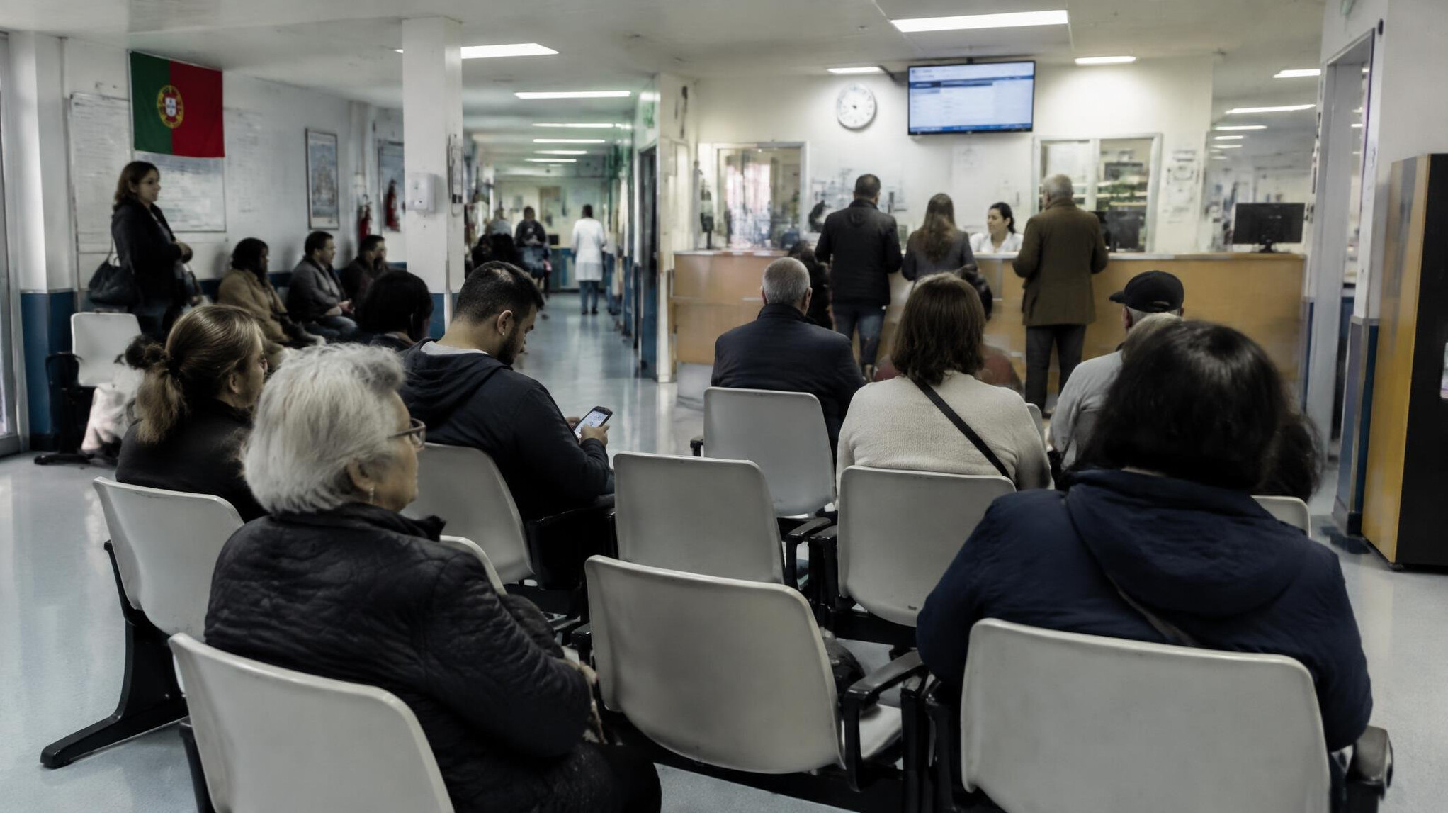 Crowded hospital waiting room with rows of empty chairs