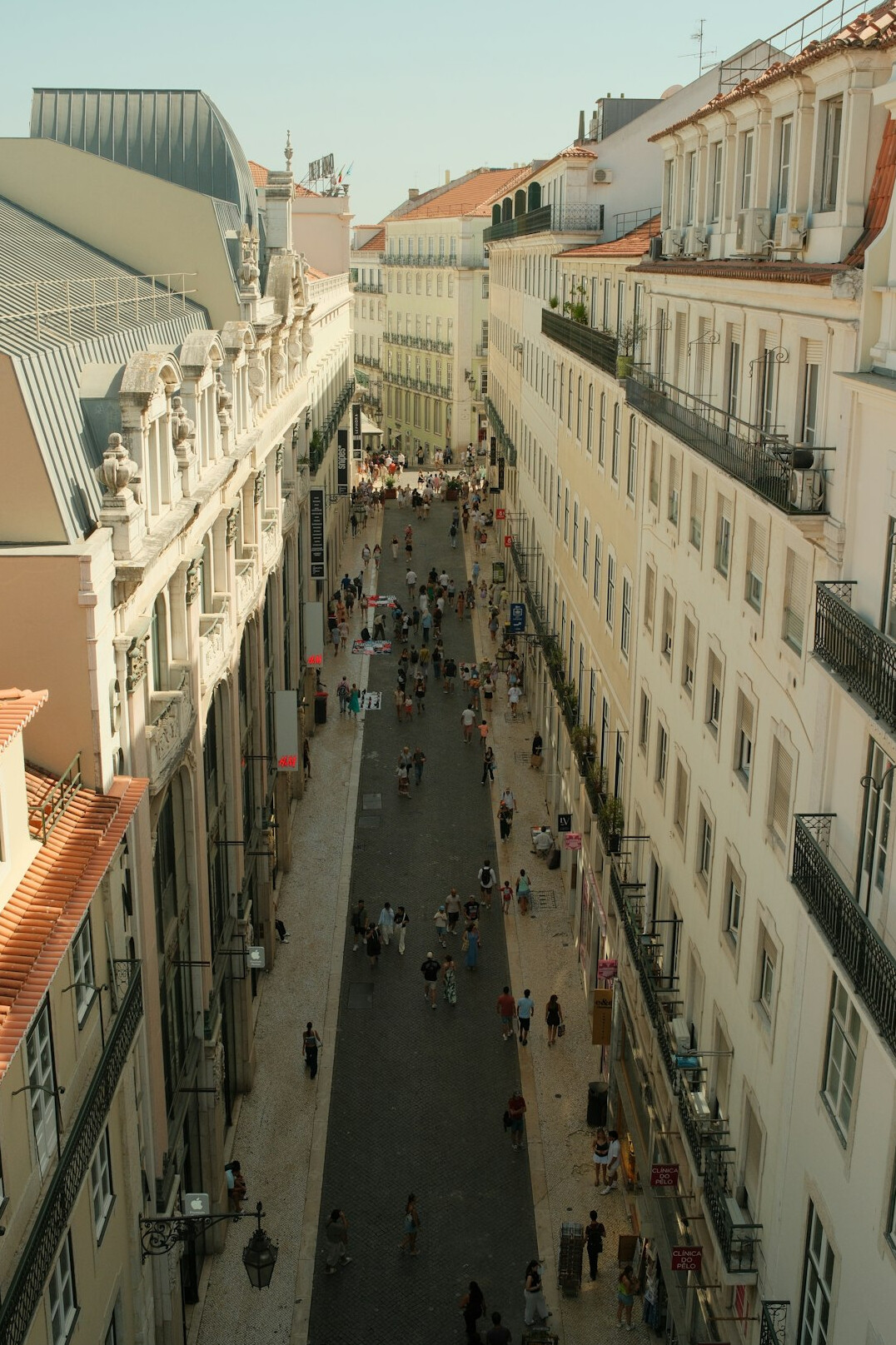 Narrow historic street crowded with tourists in Lisbon's Alfama district