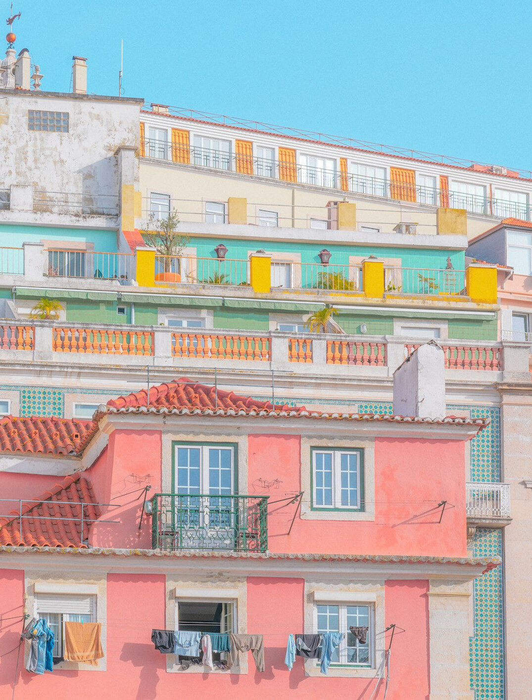 Aging apartment buildings with laundry on balconies in a Lisbon neighbourhood