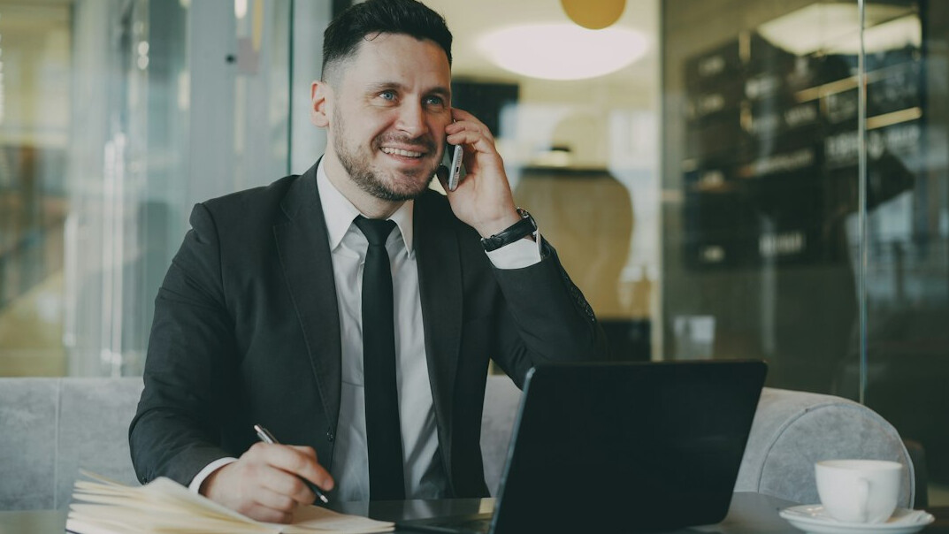 man in suit talking on phone